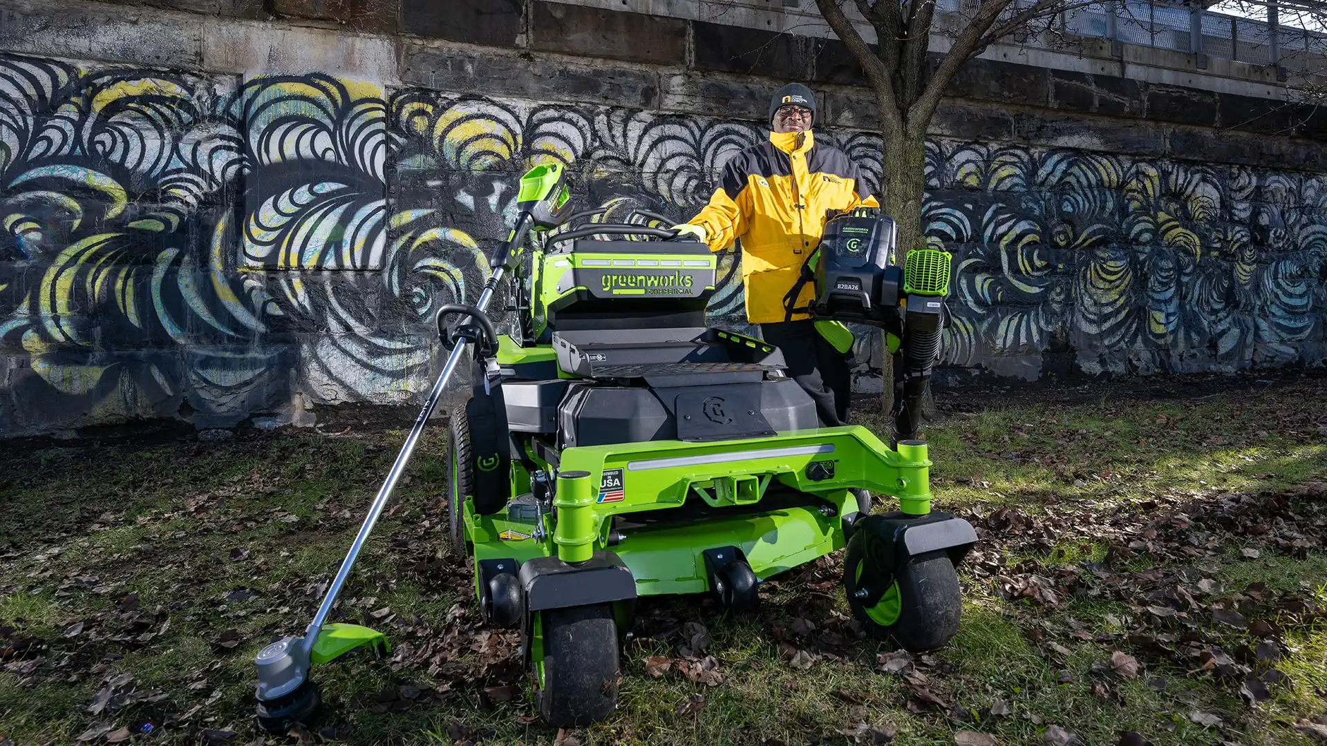 An NDD worker mowing a lawn