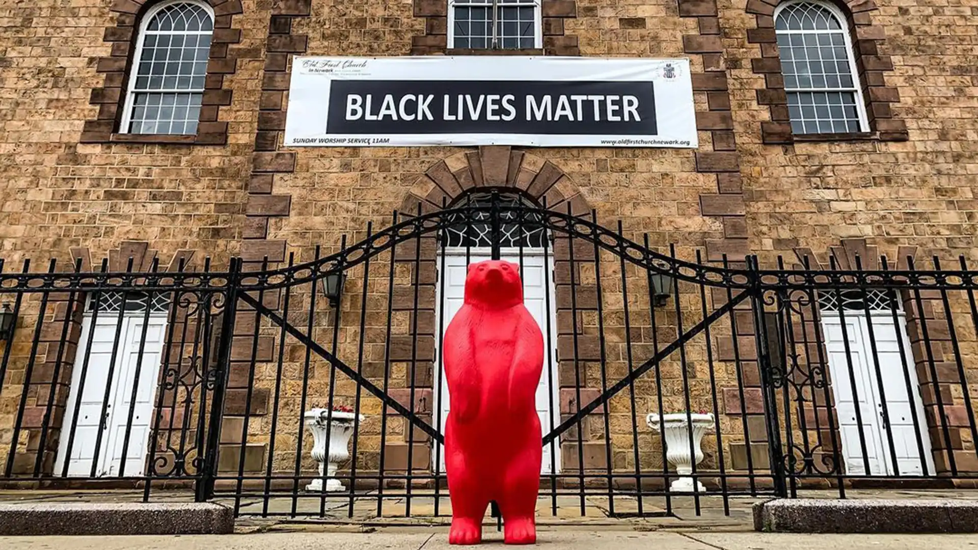 Yosemite red bear outside of a black lives matter banner on a building